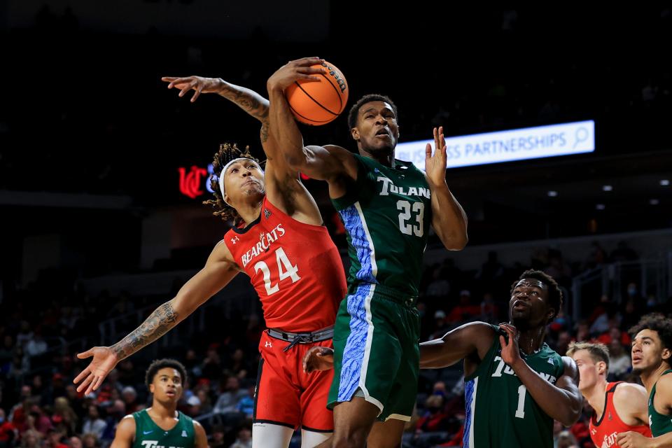 Tulane Green Wave guard R.J. McGee (23) grabs a rebound against Cincinnati Bearcats guard Jeremiah Davenport (24) in the first half at Fifth Third Arena.