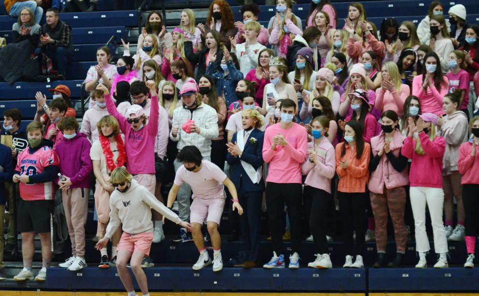 The Petoskey student section celebrates the win in the end of Friday's game against TC West in the Petoskey High School gym.
