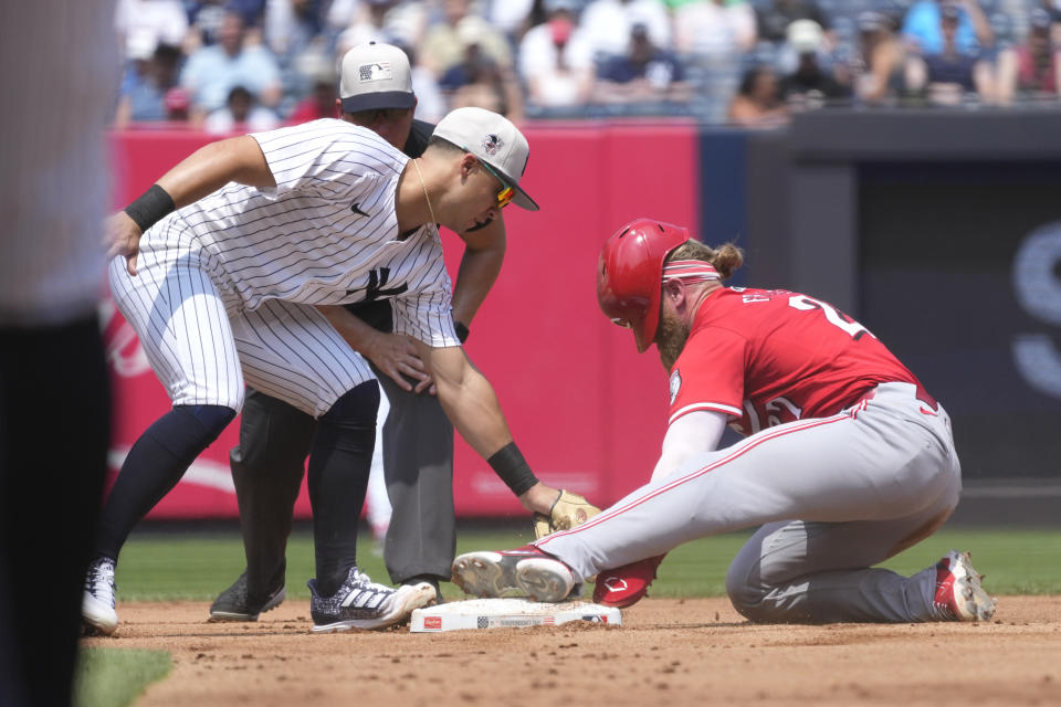 Cincinnati Reds' Jake Fraley, right, steals second base as New York Yankees second baseman Gleyber Torres attempts to tag him out during the fourth inning of a baseball game, Thursday, July 4, 2024, in New York. (AP Photo/Pamela Smith)