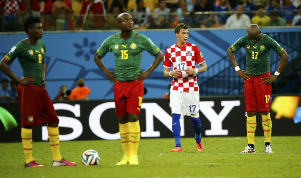 Cameroon's players wait to restart the match after Croatia's Mario Mandzukic (2nd R) scored their team's fourth goal during their 2014 World Cup Group A soccer match at the Amazonia arena in Manaus June 18, 2014. REUTERS/Murad Sezer (BRAZIL - Tags: SOCCER SPORT WORLD CUP)