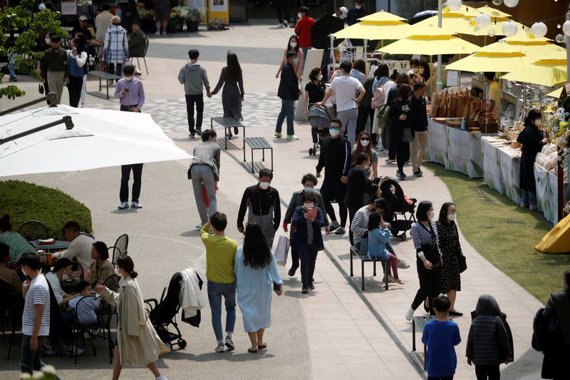 People wearing masks to avoid the spread of the coronavirus disease (COVID-19) shop at an outlet mall in Gimpo