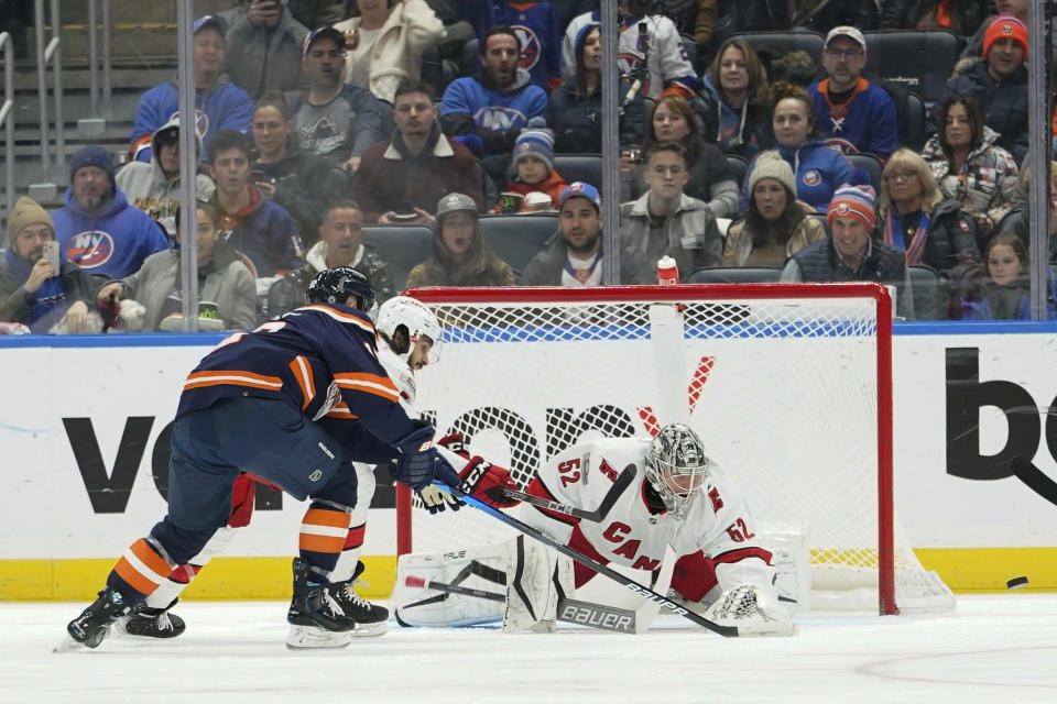 Carolina Hurricanes goaltender Pyotr Kochetkov makes the save against New York Islanders right wing Josh Bailey, left, during the first period of an NHL hockey game, Saturday, Dec. 10, 2022, in Elmont, N.Y. (AP Photo/Mary Altaffer)