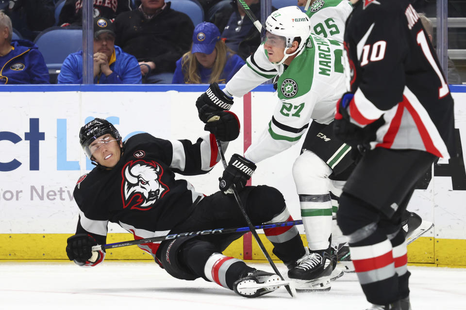 Buffalo Sabres center Peyton Krebs (19) is checked to the ice by Dallas Stars left wing Mason Marchment (27) during the second period of an NHL hockey game Tuesday, Feb. 6, 2024, in Buffalo, N.Y. (AP Photo/Jeffrey T. Barnes)