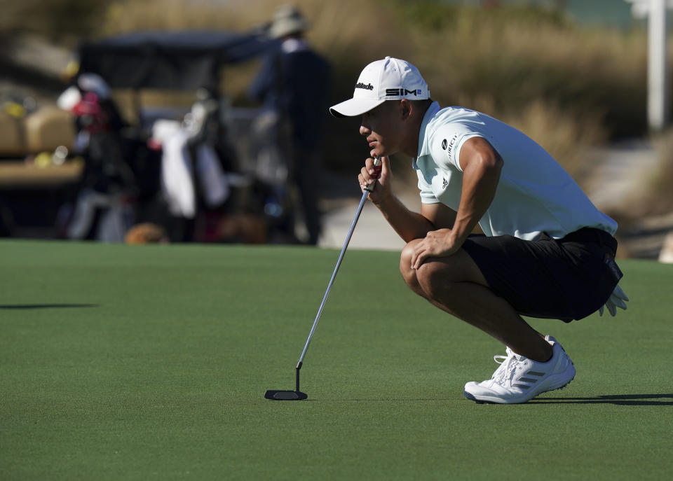 Collin Morikawa of the United States, studies his putt on the third hole during a Pro-Am tournament ahead of the Hero World Challenge PGA Tour at the Albany Golf Club, in New Providence, Bahamas, Wednesday, Dec. 1, 2021. (AP Photo/Fernando Llano)