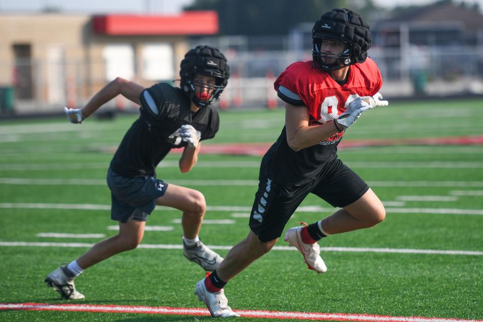 Brandon players run to catch the football at Brandon Valley High School in Brandon, South Dakota on Friday, Aug. 18, 2023.