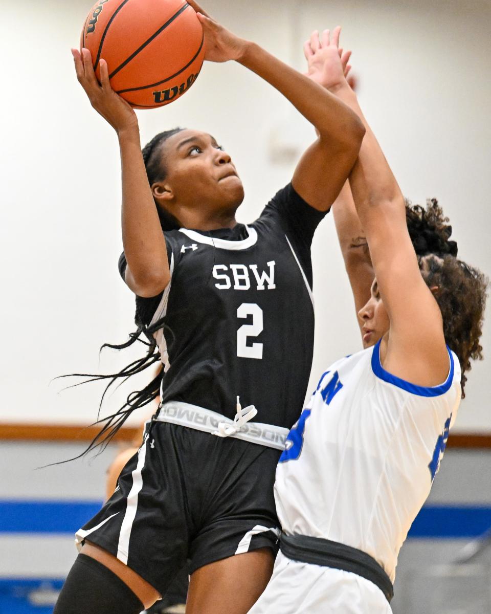 Washington Panthers guard Rashunda Jones (2) goes up for a shot as Marian Knights guard Shayla Alexander (23) defends in the first half Friday, Nov. 11, 2022, at Marian High School.