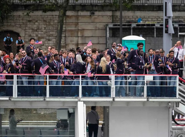 FRANCE - JULY 26: Members of Team United States wave their national flag on a boat on the River Seine during the opening ceremony of the Paris 2024 Olympic Games on July 26, 2024 in Paris, France. (Photo by Lee Jin-man - Pool/Getty Images)