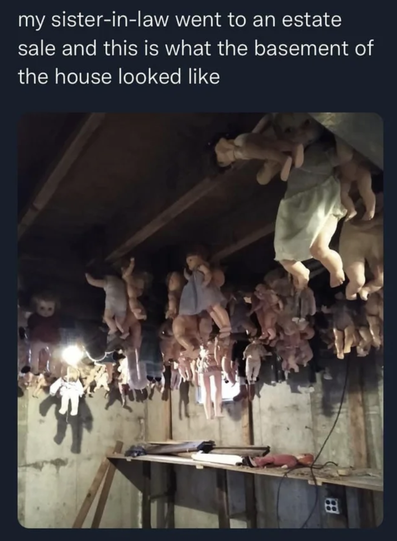 A basement with dolls hanging everywhere