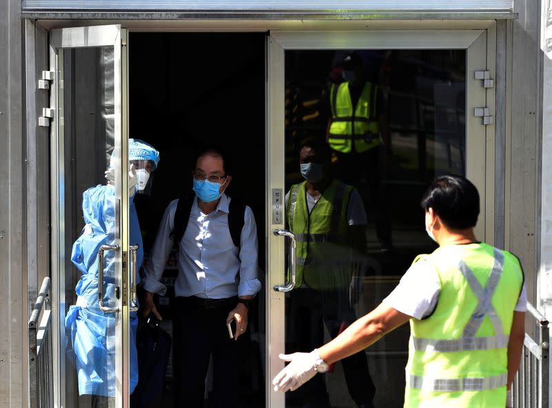 A man arriving from Malaysia leaves a COVID-19 testing center, as the Vaccinated Travel Lane between Singapore and Malaysia opens, in Singapore