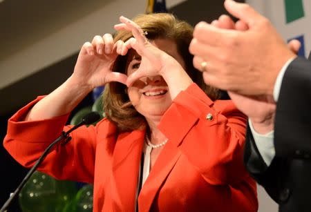 Karen Handel, Republican candidate for Georgia's 6th Congressional District, makes a heart with her fingers as she speaks to supporters during a brief appearance at her election night party at the Hyatt Regency at Villa Christina in Atlanta, Georgia, U.S., June 20, 2017. REUTERS/Bita Honarvar