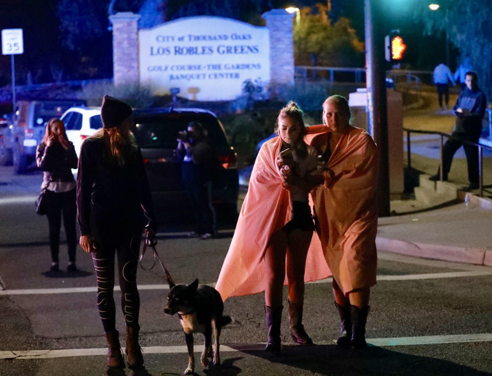 People leave the scene in Thousand Oaks.