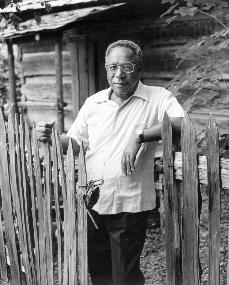 Alex Haley stands in front of a cabin at the Museum of Appalachia at Norris. Now the museum is honoring the late author as a 'hero' of Southern Appalachia.