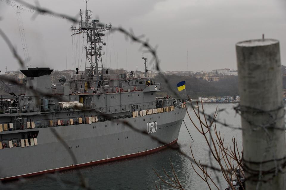 A Ukrainian national flag flies on the board of Ukrainian navy ship Slavutich, at harbor of in Sevastopol, Ukraine, Tuesday, March 4, 2014. Crimea still remained a potential flashpoint. Pro-Russian troops who had taken control of the Belbek air base in Crimea fired warning shots into the air Tuesday as around 300 Ukrainian soldiers, who previously manned the airfield, demanded their jobs back.(AP Photo/Andrew Lubimov)