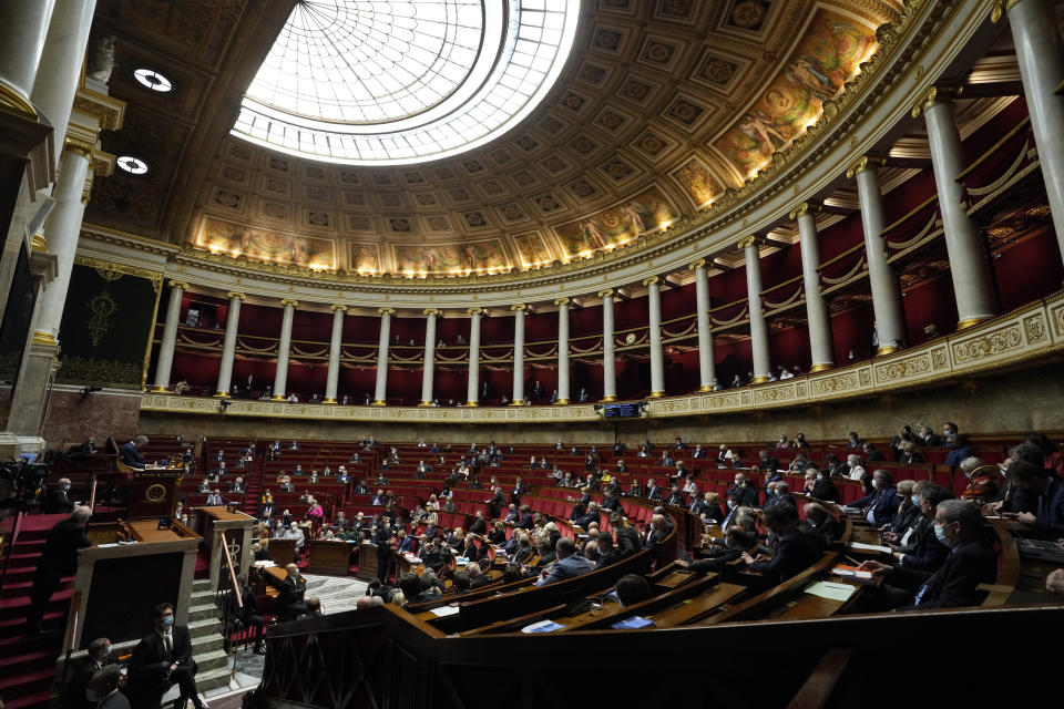 FILE - Parliament members attend a session of questions to the Government at the French National Assembly in Paris, Jan. 4, 2022. Elections for the National Assembly are organized in two rounds on June 12 and June 19, 2022. All 577 seats are up for grabs, and each winner will serve a five-year term. (AP Photo/Francois Mori, File)