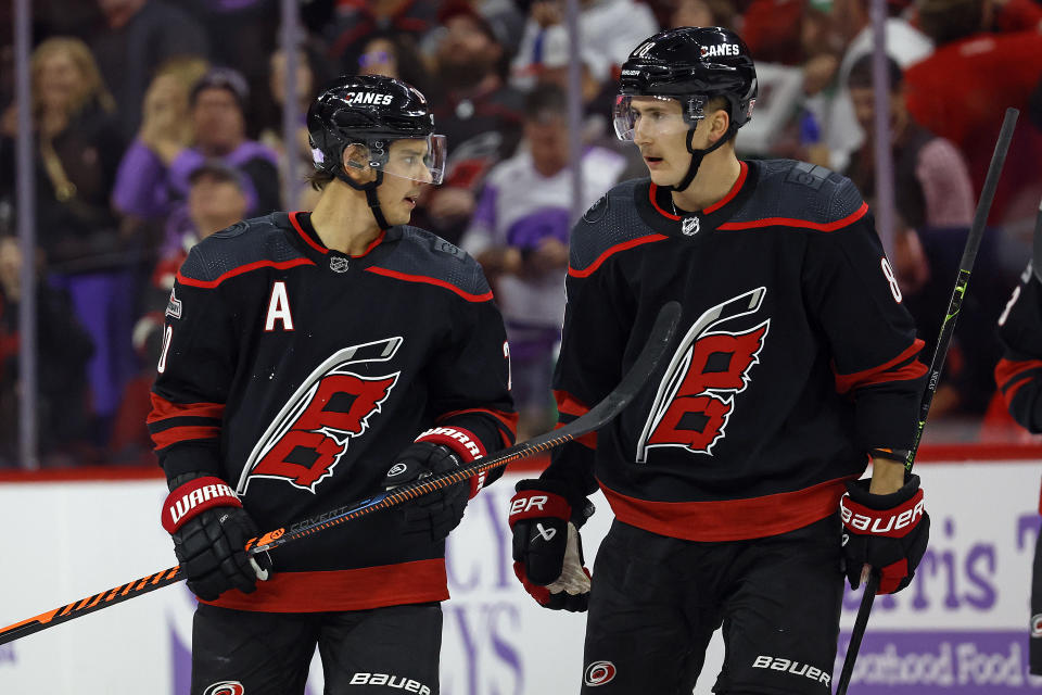 Carolina Hurricanes' Sebastian Aho, left, speaks with teammate Martin Necas (88) during the second period of an NHL hockey game against the Colorado Avalanche in Raleigh, N.C., Thursday, Nov. 17, 2022. (AP Photo/Karl B DeBlaker)