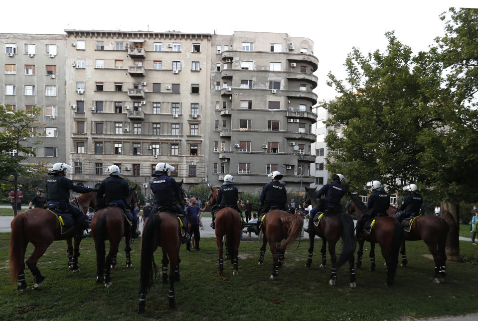 Police on their horses guard the area as people gather for a demonstration in Belgrade, Serbia, Wednesday, July 8, 2020. Serbia's president Aleksandar Vucic backtracked Wednesday on his plans to reinstate a coronavirus lockdown in Belgrade after thousands protested the move and violently clashed with the police in the capital. (AP Photo/Darko Vojinovic)