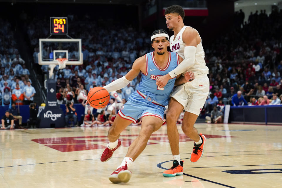 Dayton forward Toumani Camara, left, drives as SMU forward Samuell Williamson defends during the second half of an NCAA college basketball game Friday, Nov. 11, 2022, in Dayton, Ohio. (AP Photo/Joshua A. Bickel)