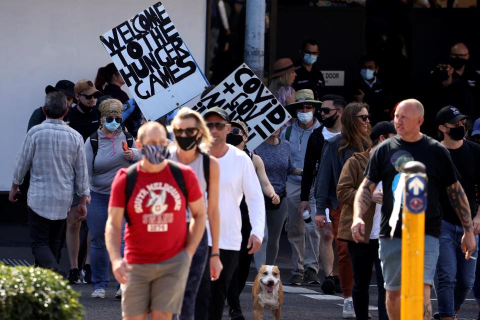 Protestors those with placards gather in Sydney on August 21, 2021, following calls for an anti-lockdown protest rally amid a fast-spreading coronavirus outbreak. (Photo by David Gray / AFP) (Photo by DAVID GRAY/AFP via Getty Images)