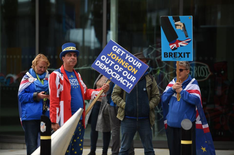 Anti-Brexit campaigner Steve Bray (2L) and fellow protesters are seen outside the Manchester Central convention centre, the venue of the annual Conservative Party conference, in Manchester, northwest England on September 28, 2019 on the eve of the start of the conference. - Embattled British Prime Minister Boris Johnson gathers his Conservative party Sunday for what could be its final conference before an election, and is set to be dominated by fighting talk on Brexit. (Photo by Oli SCARFF / AFP)        (Photo credit should read OLI SCARFF/AFP/Getty Images)