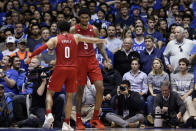 Louisville guard Lamarr Kimble (0) and forward Malik Williams (5) celebrate at the end of the team's NCAA college basketball game against Duke in Durham, N.C., Saturday, Jan. 18, 2020. Louisville won 79-73. (AP Photo/Gerry Broome)