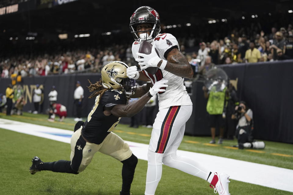 Tampa Bay Buccaneers wide receiver Trey Palmer (10) catches a touchdown pass under pressure from New Orleans Saints cornerback Isaac Yiadom (27) in the first half of an NFL football game in New Orleans, Sunday, Oct. 1, 2023. (AP Photo/Gerald Herbert)