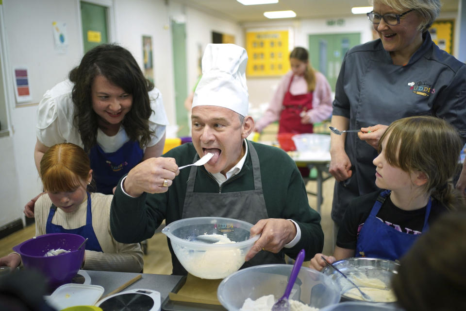 Liberal Democrats leader Sir Ed Davey taking part in a baking lesson with students from High Beeches Primary School during a half-term holiday camp in Hertfordshire, while on the General Election campaign trail, Friday May 31, 2024. (Yui Mok/PA via AP)