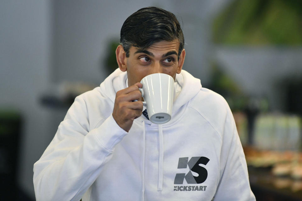 FILE - Britain's Chancellor Rishi Sunak sips a drink, as he attends a speed mentoring session for young people, during the launch of the government's Kickstart scheme aimed at helping young people into work as the labour market remains affected by the coronavirus pandemic, in Canary Wharf, London, Wednesday Sept. 2, 2020. (Daniel Leal-Olivas/Pool Photo via AP, File)