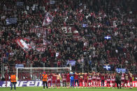 Olympiakos players celebrates in front of their fans after the end of the Europa Conference League quarter final first leg soccer match between Olympiacos and Fenerbahce at the Georgios Karaiskakis stadium, Piraeus port near Athens, Greece, Thursday, April 11, 2024. Olympiakos won the game 3-2. (AP Photo/Thanassis Stavrakis)