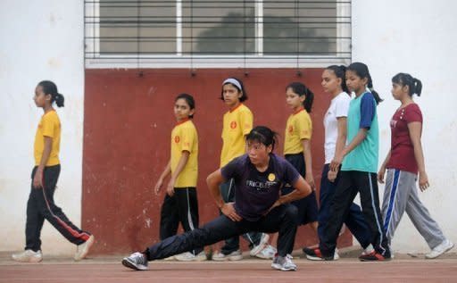 Indian boxer MC Mary Kom warms up during a training session in Pune. When she heard that women's boxing would be included in the Manipur state championships in 2000, she took to the ring and won the tournament just four months later