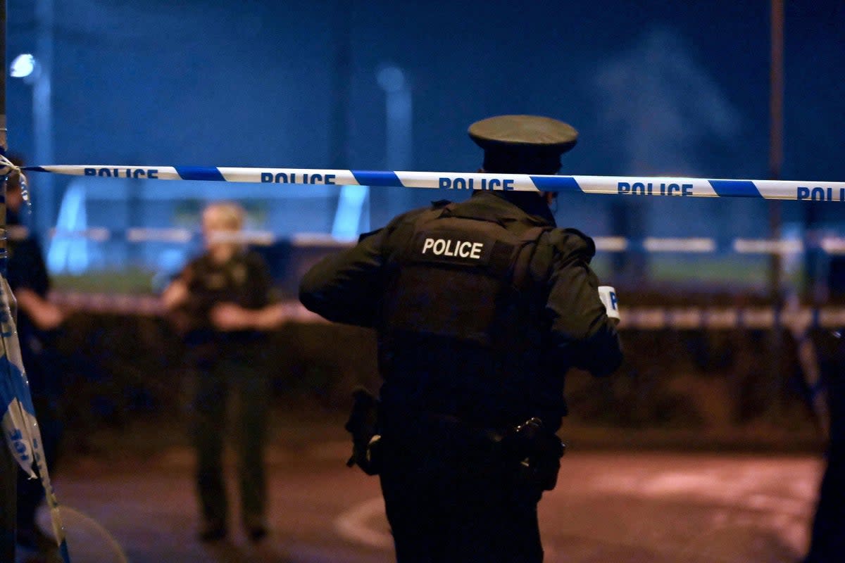 PSNI officers at the scene of a shooting in the Killyclogher Road area of Omagh (PA)