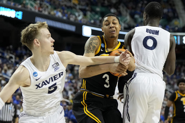 Pittsburgh forward Nate Santos drives to the basket between Xavier guard Adam Kunkel and guard Souley Boum during the first half of a second-round college basketball game in the NCAA Tournament on Sunday, March 19, 2023, in Greensboro, N.C. (AP Photo/Chris Carlson)