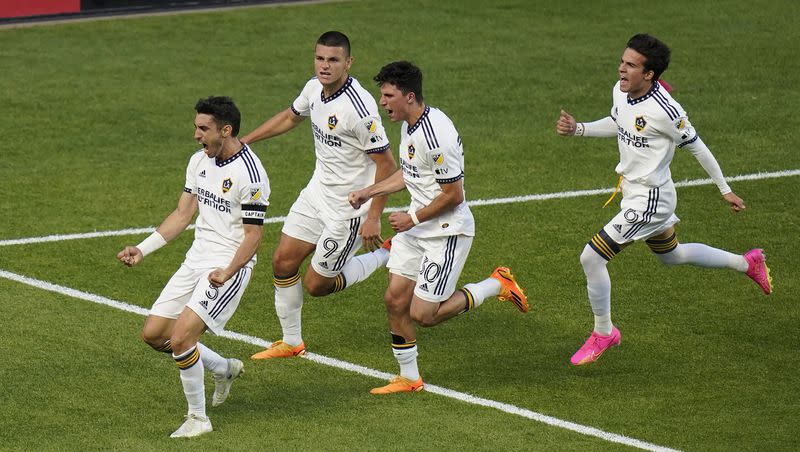 LA Galaxy midfielder Gastón Brugman, left, celebrates with teammates after scoring on a penalty kick against Real Salt Lake during the first half of an MLS soccer match Wednesday, May 31, 2023, in Sandy, Utah. (AP Photo/Rick Bowmer)