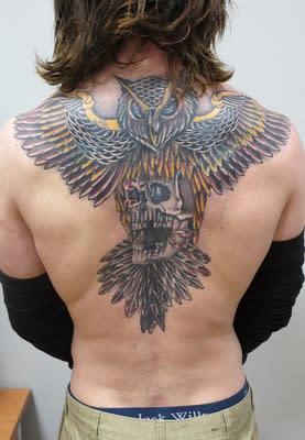 O’Brien has a distinctive owl tattoo covering his back (Met Police)