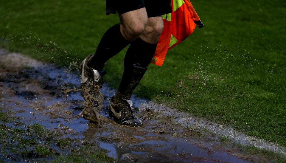 <p>Assistant referee running though mud on the touchline during the Sky Bet League Two semi final, second leg match at The New Lawn Stadium, Nailsworth. Picture date: Sunday May 23, 2021.</p>
