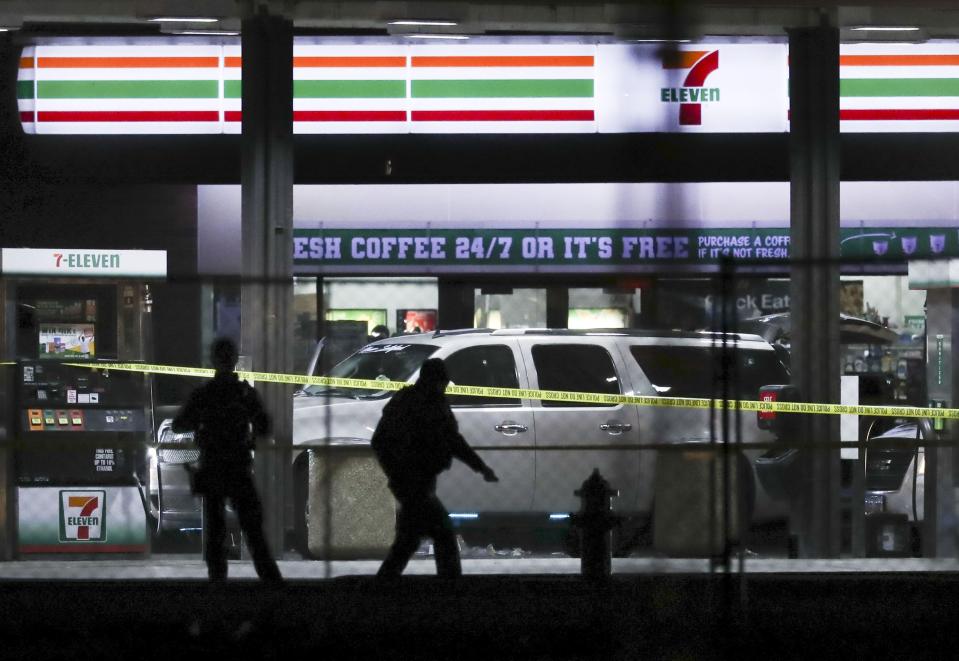 Crime tape and a heavy police presence surround a 7-11 in Taylorsville on Wednesday, Dec. 1, 2021.