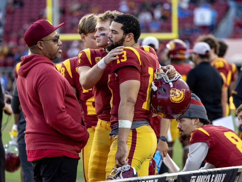 USC quarterback Caleb Williams gets a hug from USC backup quarterback Miller Moss.