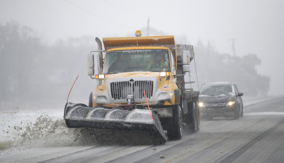 A plow clears snow from Road 438 in Douglas County near Lawrence, Kan., Sunday, Nov. 25, 2018. The area is under a blizzard warning. (AP Photo/Orlin Wagner)