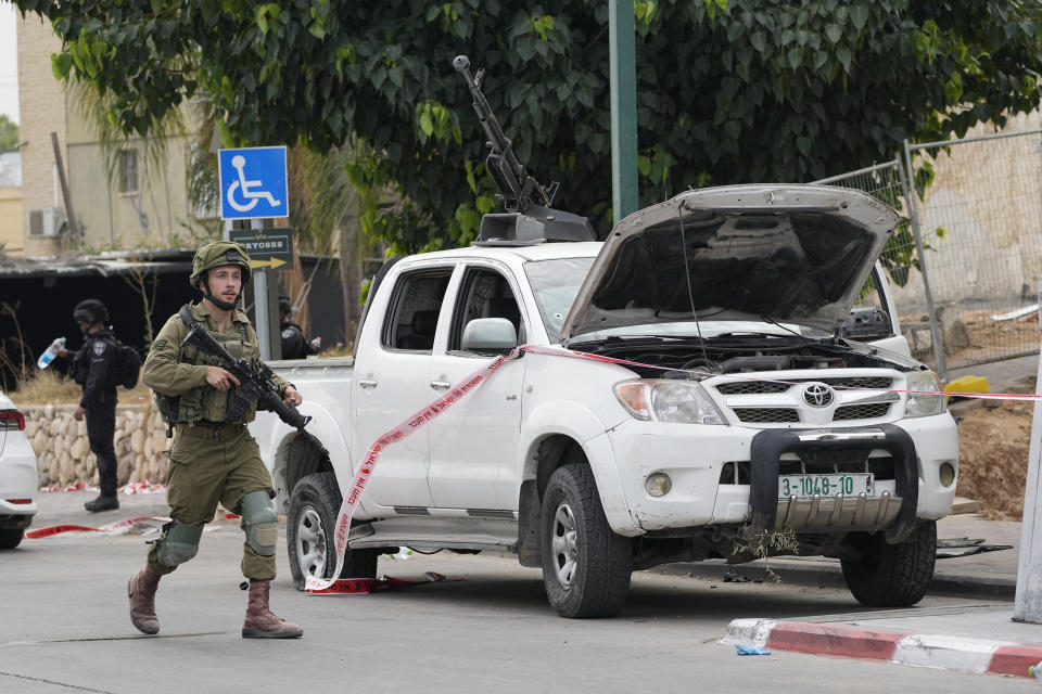 CORRECTS SPELLING OF LAST NAME TO HALIVA FILE - Israeli soldier walks by a pickup truck used by Palestinian militants in Sderot, Israel, on Saturday, Oct. 7, 2023. The Israeli military said Monday April 22, 2024 that the head of its intelligence corps has resigned over Hamas’ Oct. 7 attack. Aharon Haliva, the head of Israel’s military intelligence, becomes the first senior Israeli figure to step down over the failures surrounding Hamas’ attack. (AP Photo/Ohad Zwigenberg, File)