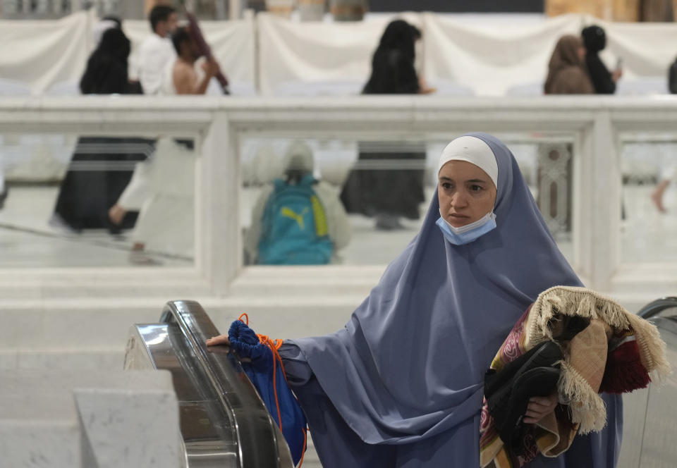 A Muslim pilgrim leaves the Grand Mosque, in Mecca, Saudi Arabia, Wednesday, July 6, 2022. Muslim pilgrims are converging on Saudi Arabia's holy city of Mecca for the largest hajj since the coronavirus pandemic severely curtailed access to one of Islam's five pillars. (AP Photo/Amr Nabil)