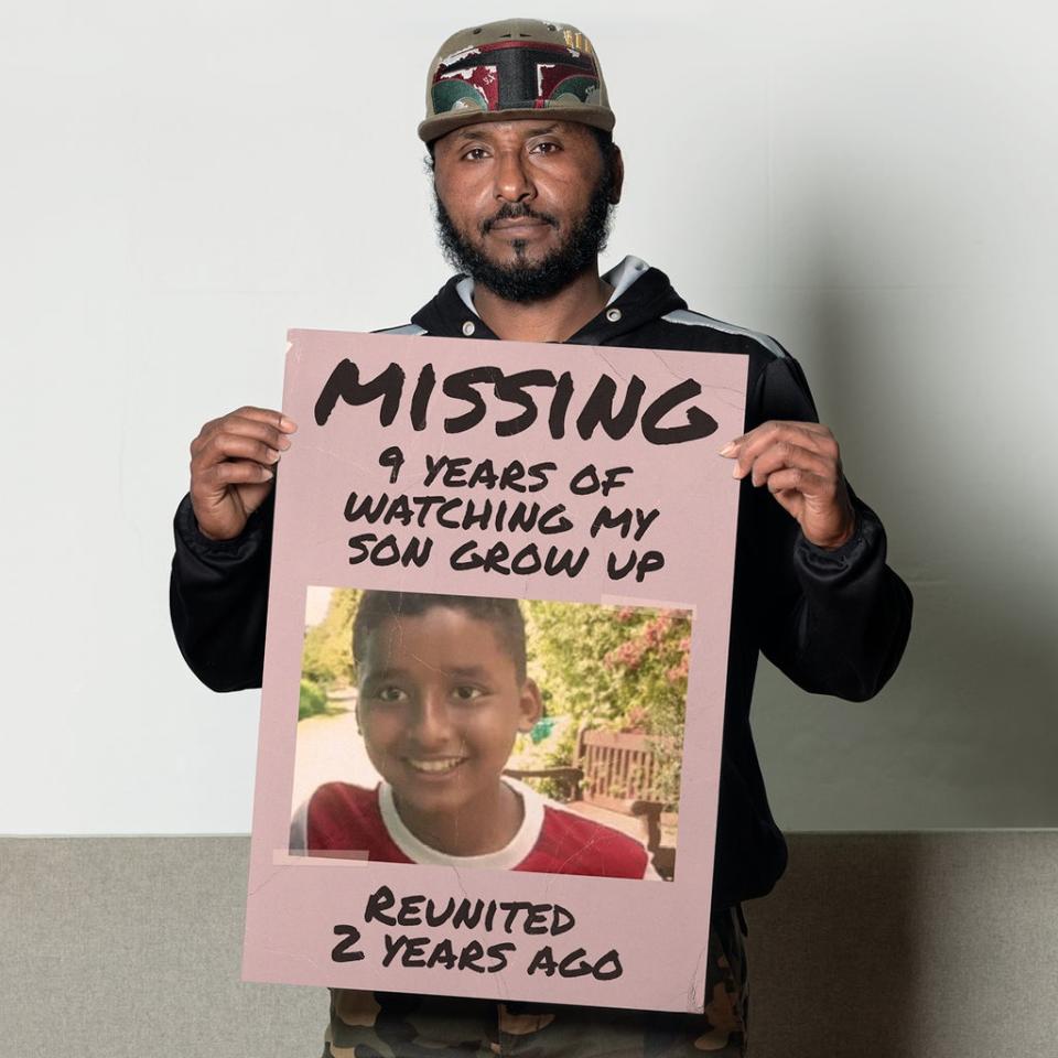 Osman pictured holding a missing poster, which mentions that he missed out on nine years with his son (Inzajeano Latif/Migrant Help/PA)