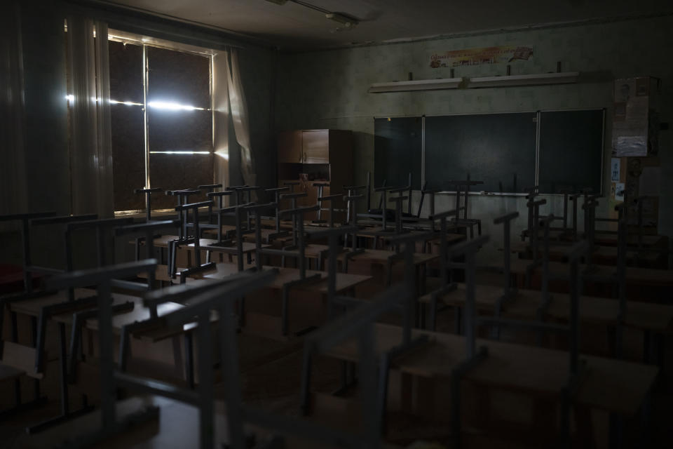 The windows of a classroom in a primary school are blocked for protection from shelling in Kupiansk, Ukraine, Wednesday, Aug. 23, 2023. There are still 451 children in Kupiansk who's parents have refused evacuation pleas, despite intensified offensive operations by Russian forces in recent weeks. (AP Photo/Bram Janssen)