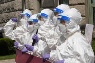 Members of the Korean Health Workers Union wearing protective gear shout slogans during a rally to call for an increase in the number of nurses assigned to Covid-19 treatment wards and for better treatment of medical personnel in Seoul, South Korea, Thursday, Aug. 5, 2021. (AP Photo/Ahn Young-joon)