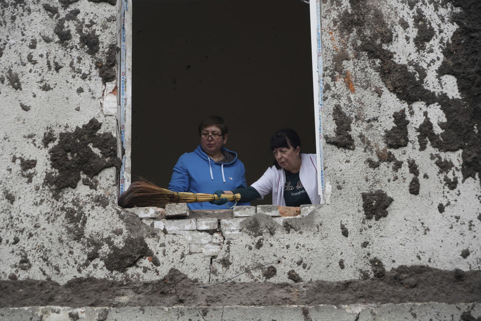 Nurses clean up in the room after a Russian attack on mental hospital №3 in Kharkiv, Ukraine, Saturday, April 27, 2024. (AP Photo/Andrii Marienko)