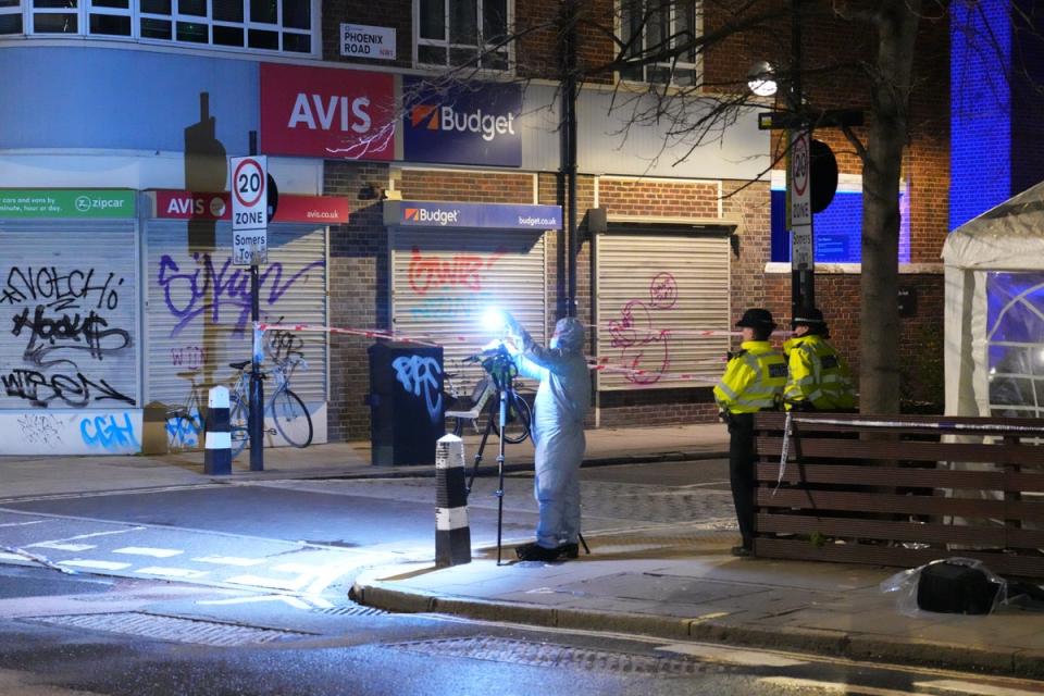 Police forensic officers attend the scene of a shooting near St Aloysius RC Church (Getty Images)