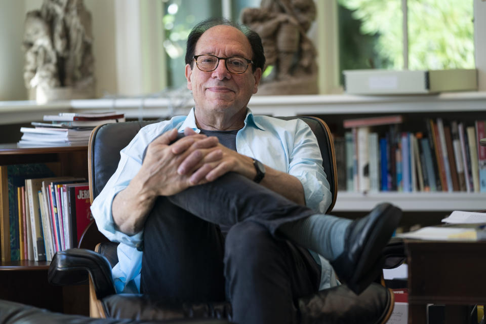 Playwright Ken Ludwig poses for a portrait in his home, Friday, Aug. 12, 2022, in Washington. Ludwig has revisited one of his most beloved plays and flipped the characters’ genders. “Lend Me a Soprano” inverts Ludwig’s madcap screwball comedy “Lend Me a Tenor” by having ladies take the lead three parts, a change he initiated so that a whole new raft of comedians could shine. “Lend Me a Soprano” makes its world premiere this fall at the Ally Theatre in Houston on Sept. 16. (AP Photo/Evan Vucci)