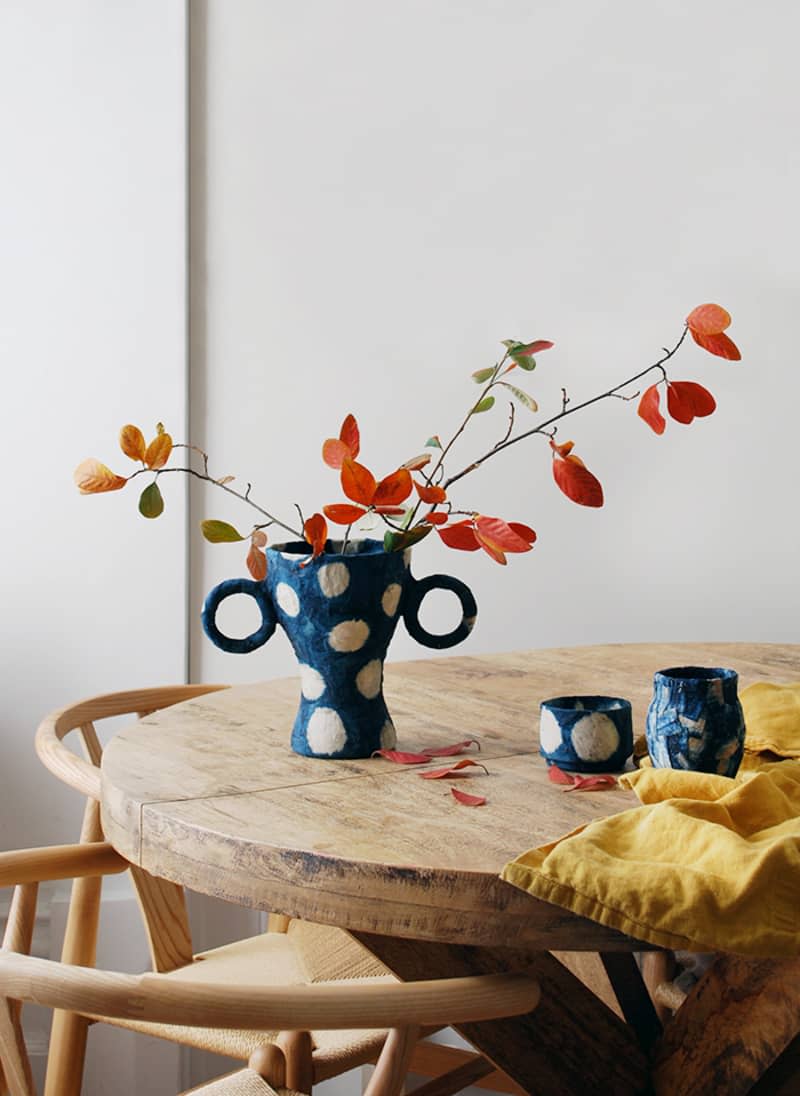 Blue polka dot vase with handles on table