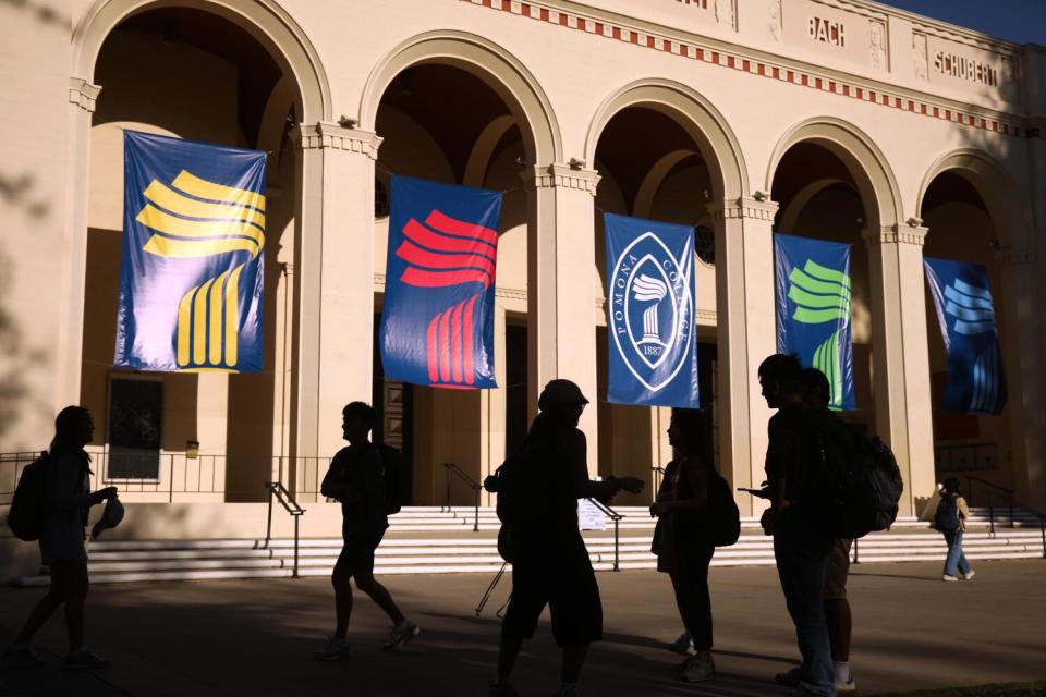 Pomona College students walk by Bridges Auditorium on campus.