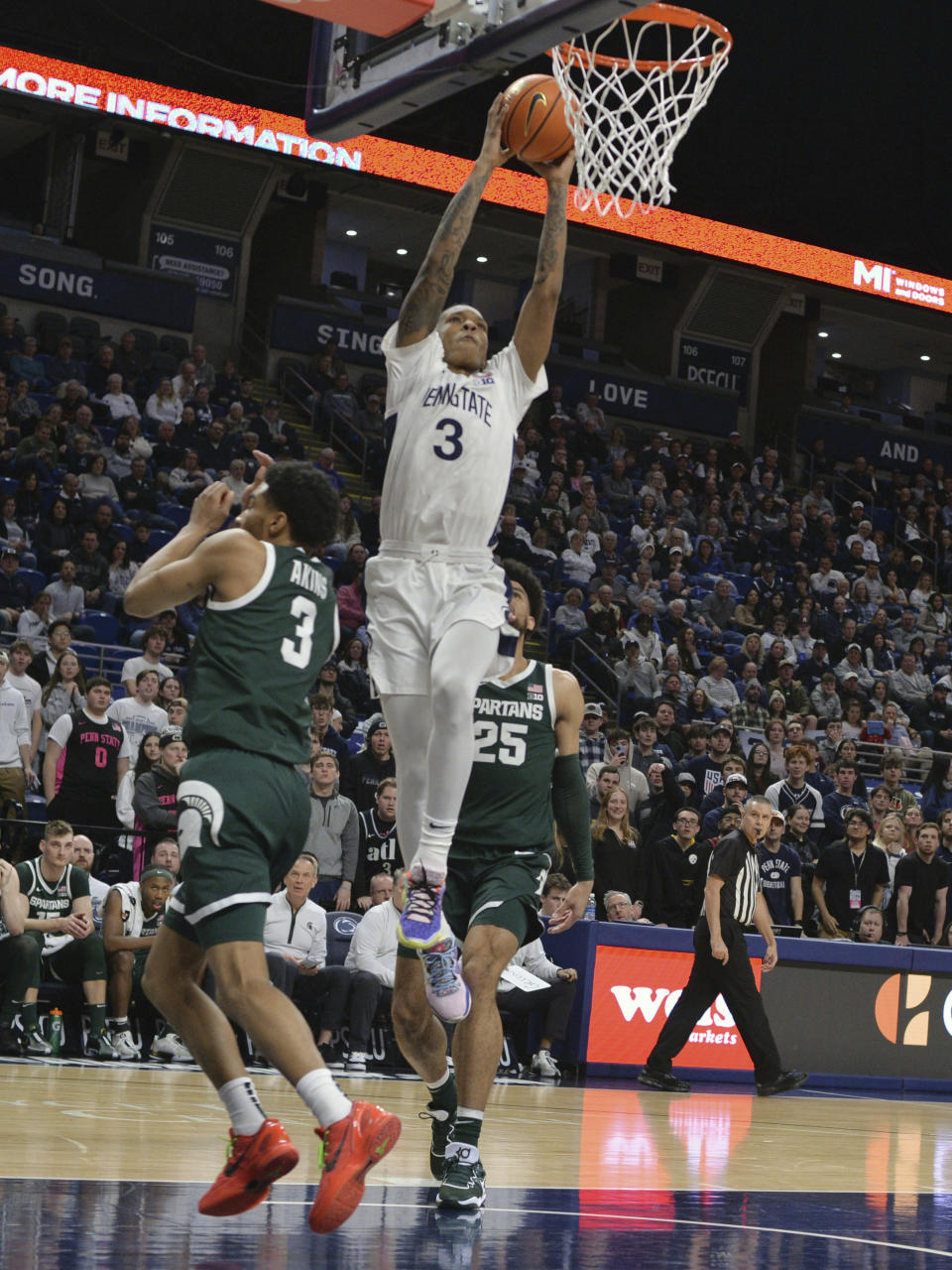 Penn State's Nick Kern Jr. (3) goes up for a dunk past Michigan State's Jaden Akins (3) during the first half of an NCAA college basketball game Wednesday, Feb. 14, 2024, in State College, Pa. (AP Photo/Gary M. Baranec)