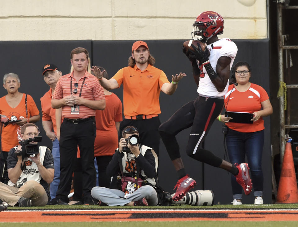 An Oklahoma State fan reacts to Texas Tech wide receiver T.J. Vasher catching a pass in the end zone for a touchdown during the first half of an NCAA college football game in Stillwater, Okla., Saturday, Sept. 22, 2018. (AP Photo/Brody Schmidt)