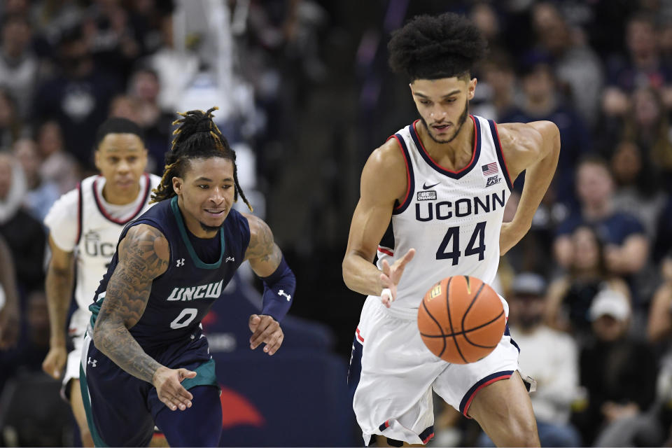 Connecticut's Andre Jackson Jr. (44) steals the ball from UNC Wilmington guard Jamarii Thomas (0) in the second half of an NCAA college basketball game, Friday, Nov. 18, 2022, in Storrs, Conn. (AP Photo/Jessica Hill)